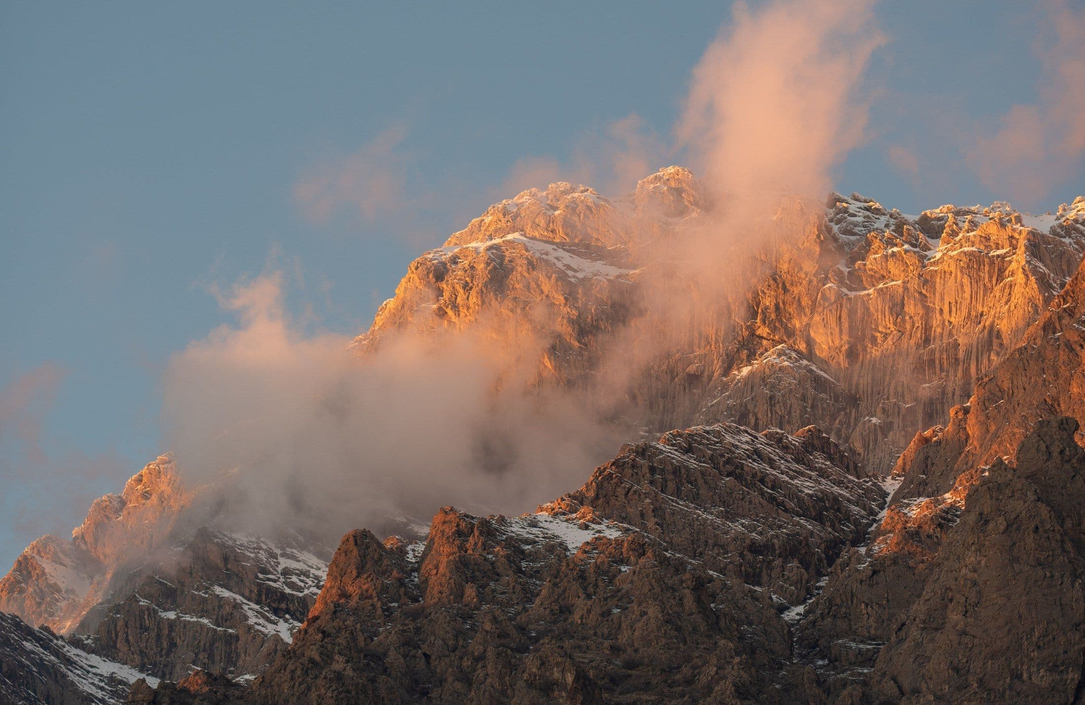 Snow-dusted mountains of Kurdistan glowing at golden hour