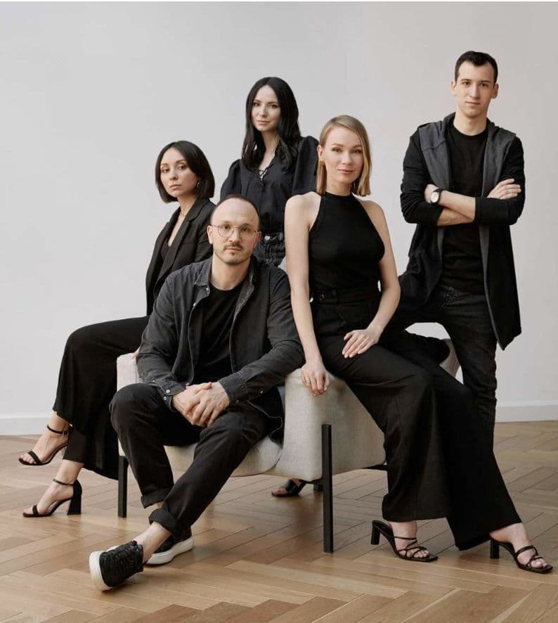 Agency team photographed together in a bright studio