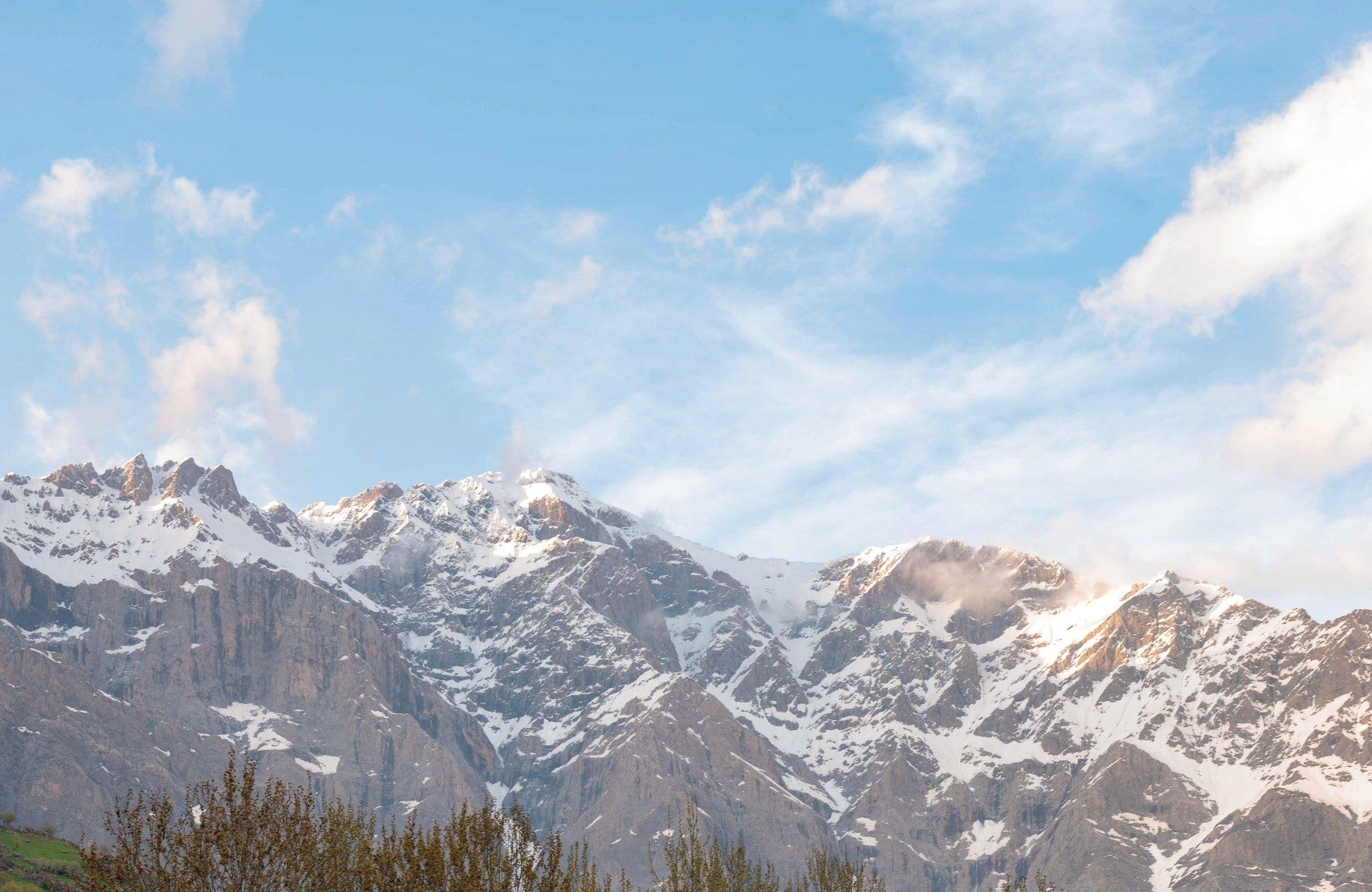 Snow-capped peaks rising above the tree line in Kurdistan