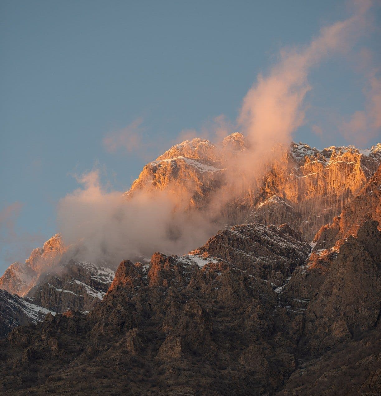 Cloud breaking over a sunlit mountain ridge in Kurdistan